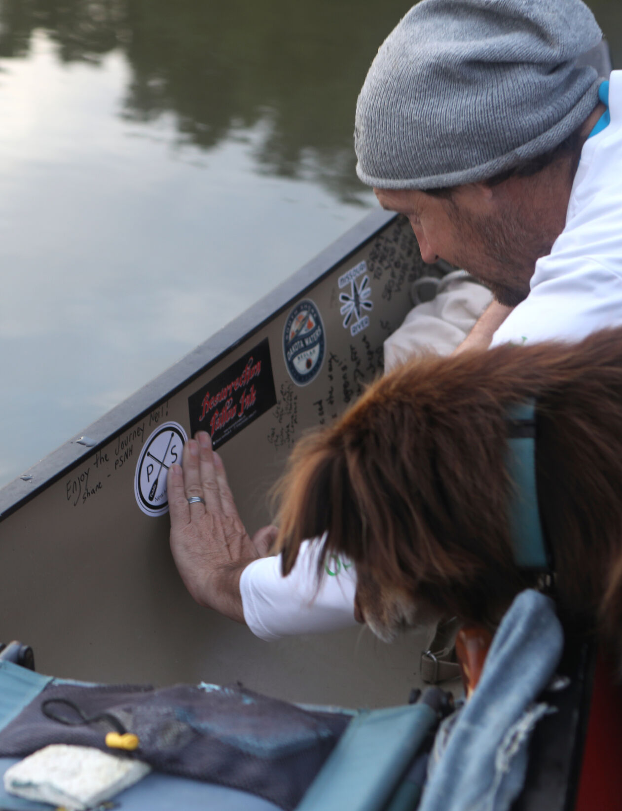 Shane Camden and Brewster place a sticker